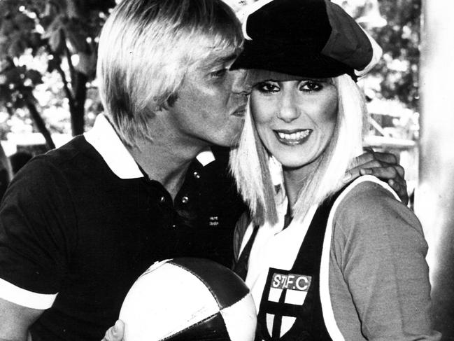 1981. Cher whizzed into Melbourne yesterday and showed St Kilda footballers how their guernseys should be worn.Cher was made an honorary member of the club and was more than pleased to receive a No.2 guernsey from club star Trevor Barker, who wears No.1And shoppers in the heart of Collins St., where it all happened, were more than a little startled and eager to get autographs from the two stars.Cher will be performing at the Palais in St Kilda tonight, tomorrow night and Monday, and rest assured her costumes will be a sight more alluring than this one …Especially if you’re not a St Kilda fan.Singer. Football. Jumper. Celebrity. Melbourne. Neg: 811203/34(hsretro instagram 16/03/2017)