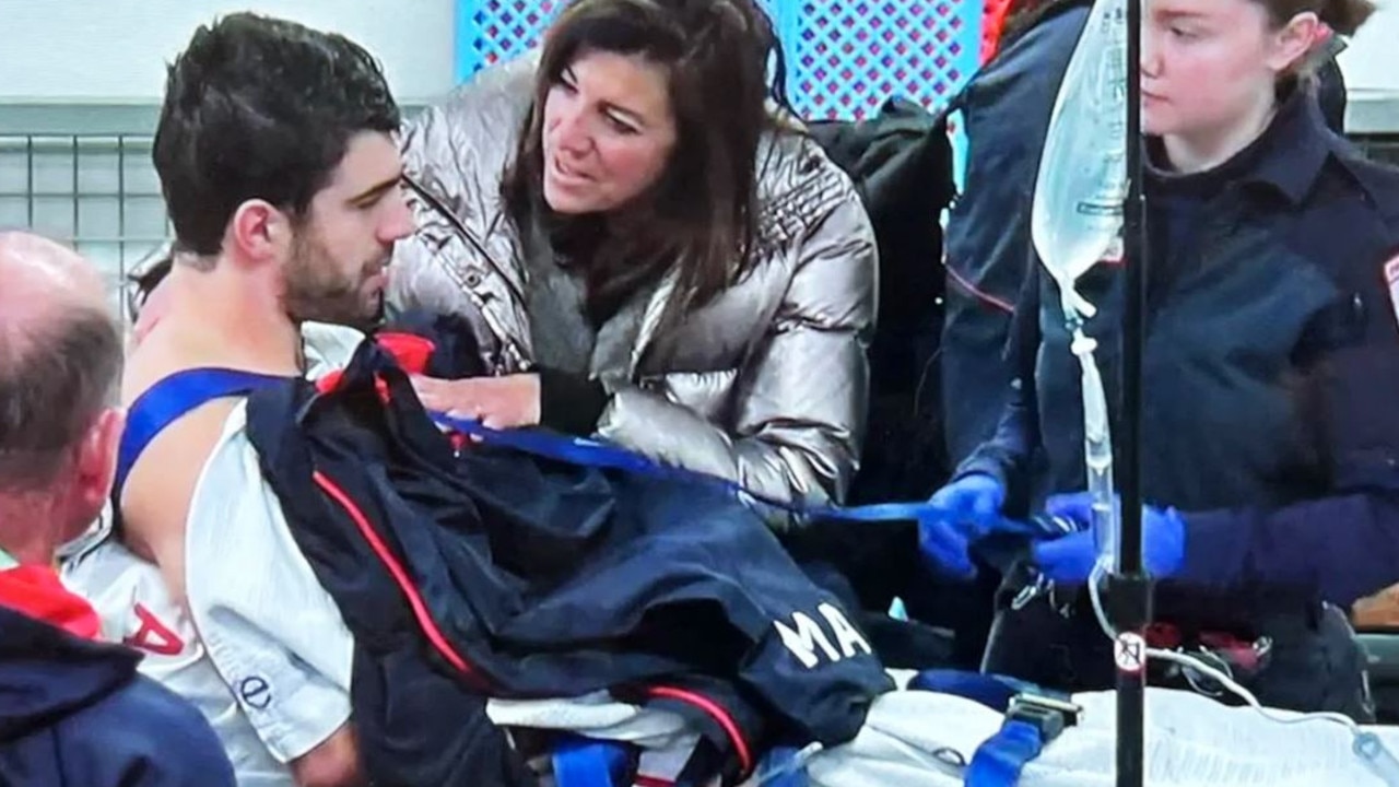 Christian Petracca is consoled by his mum before being taken to hospital.