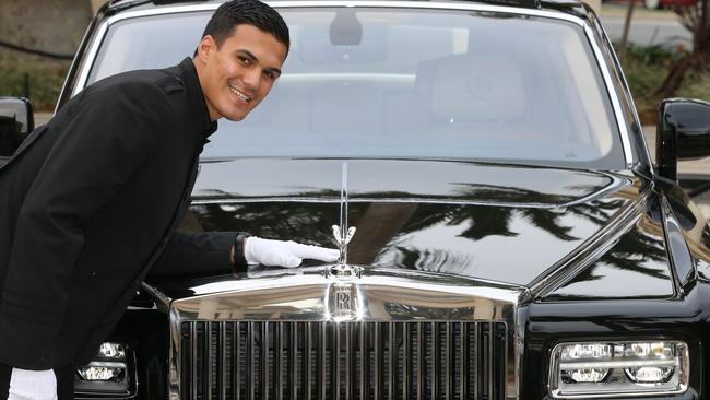 . Concierge Isaac Nathan with one of the Rolls Royce. Photo: Glenn Hampson