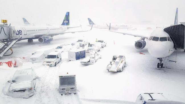 Planes wait at the gates outside terminal five at New York’s John F. Kennedy International Airport in the heavy snow.