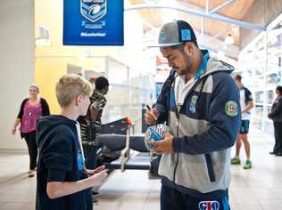 Jarryd Hayne signs a ball for Bryce Sully as the Blues fly out of Coffs Harbour. . Picture: Rob Wright