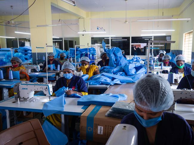 Women sew personal protection equipment gear inside the Sipra Surgi-Med PPE manufacturing facility in Bengaluru, India. Picture: Getty Images