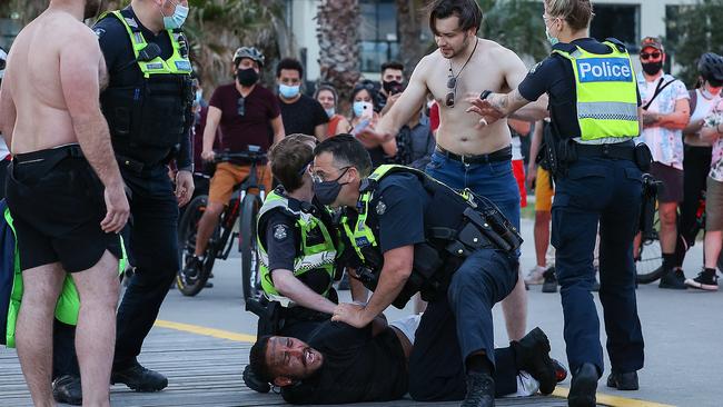 Crowds gather as the man is handcuffed by police Picture: Ian Currie