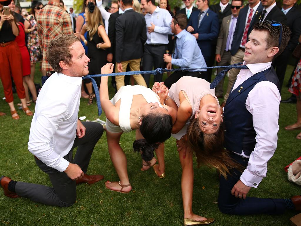 These punters have an impromptu game of limbo. Picture: Scott Barbour/Getty Images