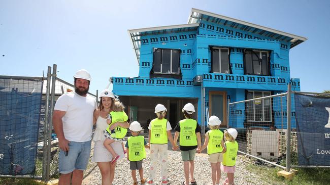 Danielle and Rhys Carroll with their kids and the kids of Kelly Wilkinson outside the house which is being built for them entirely through donations after Kelly’s alleged murder. Picture Glenn Hampson