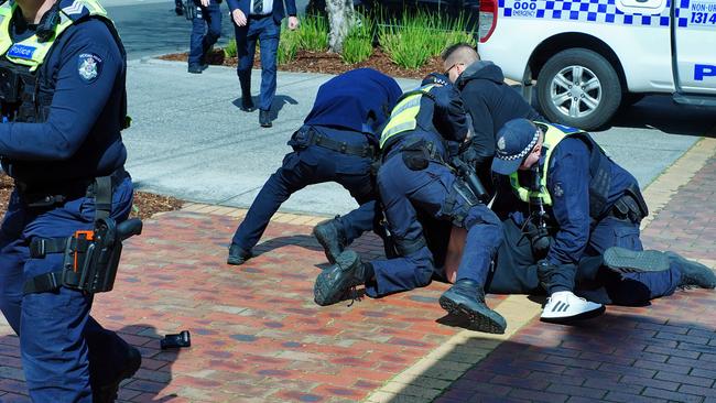 MELBOURNE AUSTRALIA - NewsWire Photos September 9, 2023: Police restrain a person at the scene of a shooting. Gavin Preston, an infamous Melbourne crime figure, was killed in an ambush shooting at a shopping centre in Keilor East, about 15 kms north-west of Melbourne on Saturday. Two shooters are believed to still be on the run.Picture: NCA NewsWire/Luis Ascui