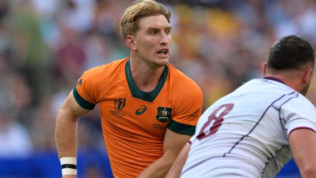 Australia's scrum-half Tate McDermott (L) runs with the ball during the France 2023 Rugby World Cup Pool C match between Australia and Georgia at Stade de France in Saint-Denis, on the outskirts of Paris, on September 9, 2023. (Photo by Miguel MEDINA / AFP)