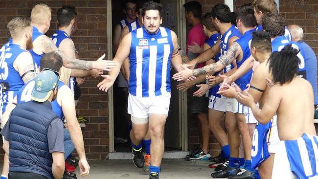 The Moorabbin reserves cheer on the seniors as they run on to the ground.