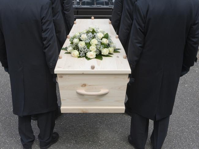 Bearers carrying a coffin into a car.  Death and funerals.  Picture: iStock