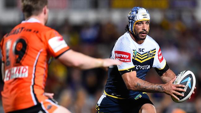 TOWNSVILLE, AUSTRALIA - AUGUST 09: Johnathan Thurston of the Cowboys runs the ball during the round 22 NRL match between the North Queensland Cowboys and the Wests Tigers at 1300SMILES Stadium on August 9, 2014 in Townsville, Australia. (Photo by Ian Hitchcock/Getty Images)