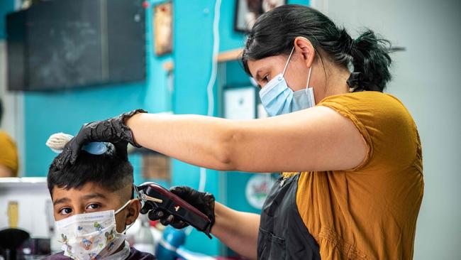 A young man gets his hair cut at a barbershop amid the coronavirus pandemic in Austin, Texas. Picture: AFP