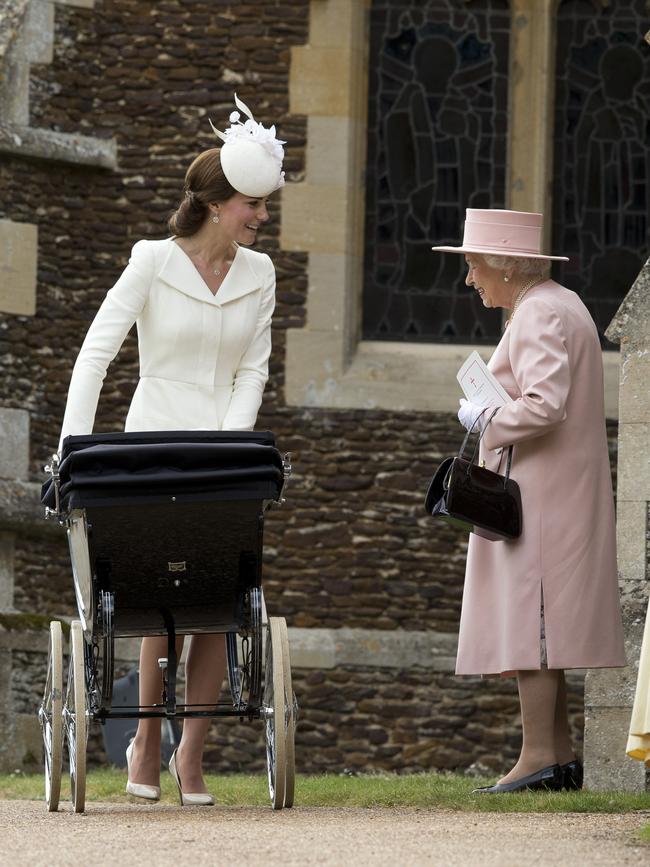 Queen Elizabeth II speaks to Catherine, Duchess of Cambridge, as she pushes in a pram Princess Charlotte of Cambridge at Church of St Mary Magdalene on the Sandringham Estate after the Christening of Princess Charlotte of Cambridge on July 5, 2015 in King’s Lynn, England. Picture: Getty