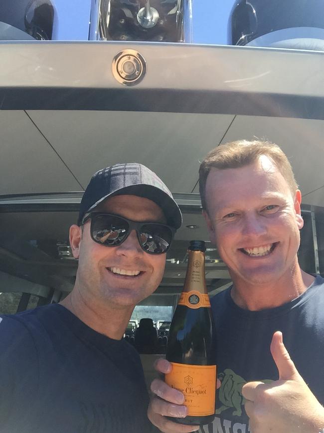 Good mates Michael Clarke (left) and Anthony Bell on an earlier trip on the yacht.