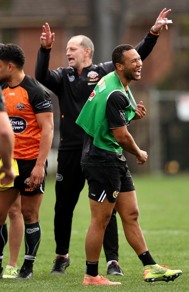 Moses Mbye and coach Michael Maguire during a Wests Tigers training session. Picture: Phil Hillyard