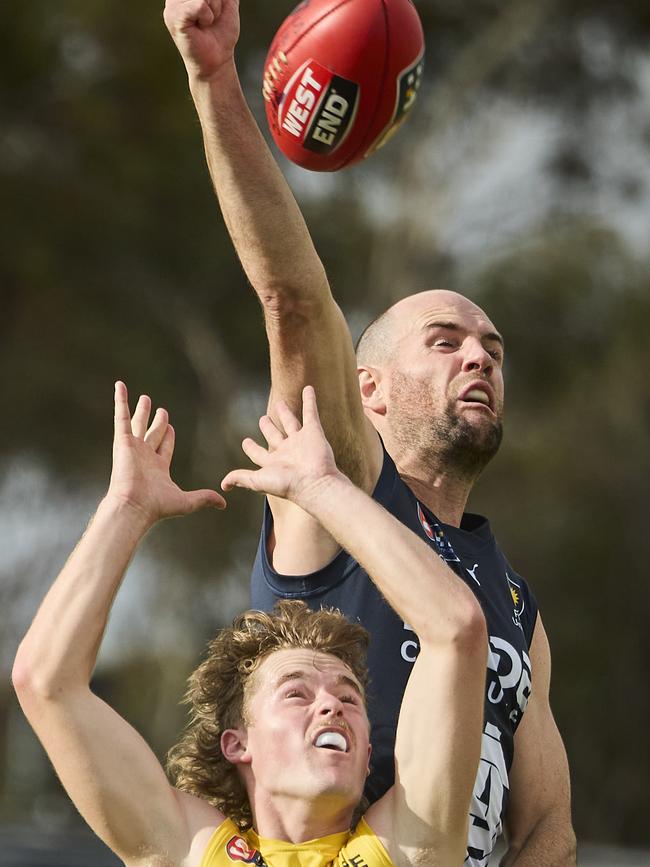 South Adelaide’s Matthew Broadbent, playing his 100th SANFL game, spoils the marking attempt of Eagle Max Beattie at Noarlunga Oval. Picture: Matt Loxton