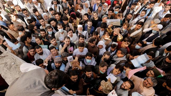 Many people were turned away and officials had to beat back the crowds that converged on the passport office in Kabul on Wednesday. Picture: Reuters