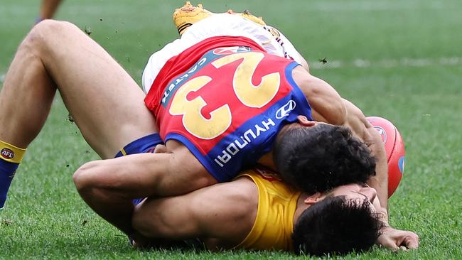 PERTH, AUSTRALIA - JULY 14: Liam Duggan of the Eagles lies concussed tackled by Charlie Cameron of the Lions during the 2024 AFL Round 18 match between the West Coast Eagles and the Brisbane Lions at Optus Stadium on July 14, 2024 in Perth, Australia. (Photo by Will Russell/AFL Photos via Getty Images)