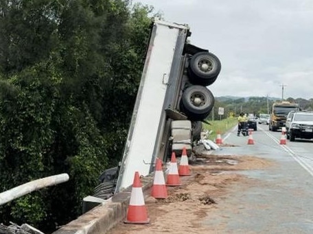 A truck has been left dangling precariously cab-first off a bridge on the Gold Coast on Monday night. The truck smashed into the barrier and off the bridge on Pimpama Jacobs Well Rd in Pimpama about 11.43pm. The cab of the truck became submerged in the river below, with the back tires stopping the truck from completely toppling over.