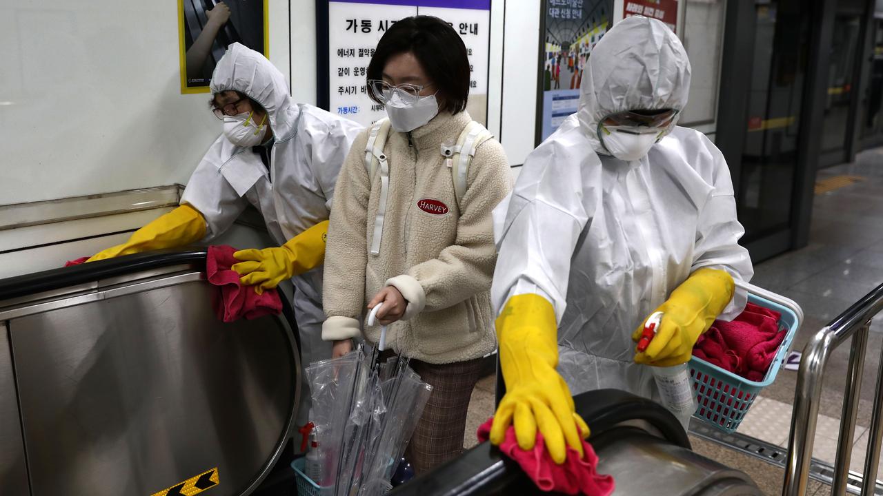 Disinfection professionals have taken to disinfecting subway stations in a bid to prevent the virus from spreading in Seoul, South Korea. Picture: Chung Sung-Jun/Getty Images.