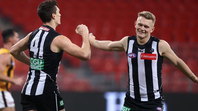 Brody Mihocek and Adam Treloar celebrate another Pies goal.