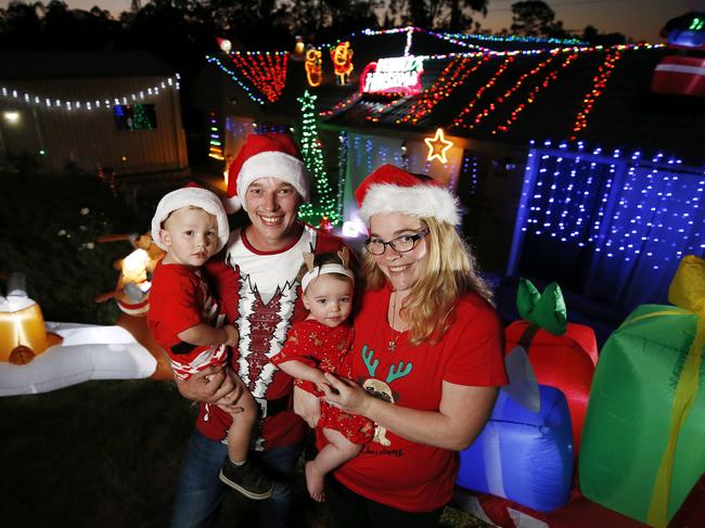 Andy and Katelyn Parsons with Theo, 2.5, and Georgie, 1.5, posing at their home in Collingwood Park, Brisbane 15th of October 2020.   Andy has spent a good amount on his Christmas lights display this year.  (Image/Josh Woning)