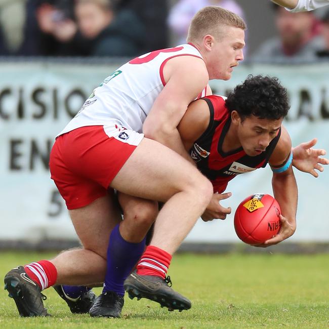 Stawell’s Riley Ika gathers the ball as Ararat’s Robert Armstrong comes into tackle.