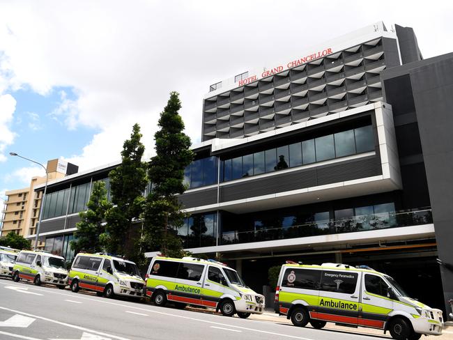 BRISBANE, AUSTRALIA - NewsWire Photos - JANUARY 13, 2021.Ambulance crews prepare to transport quarantined guests from the Hotel Grand Chancellor in Spring Hill, Brisbane. Guests will be evacuated after six people linked to the building tested positive to the highly-contagious UK variant of the coronavirus.Picture: NCA NewsWire / Dan Peled