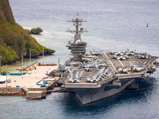 (FILES) This file US Navy photo shows the aircraft carrier USS Theodore Roosevelt (CVN 71)as it is moored pier side at Naval Base Guam on May 15, 2020. - A US aircraft carrier group sailed into the South China Sea on a so-called "freedom of navigation" exercise, the first routine operation in the region under new President Joe Biden. Led by the USS Theodore Roosevelt, the carrier strike group entered the area on January 23, 2021, the US Indo-Pacific Command said, the same day Taiwan reported multiple Chinese jets and bombers had flown into its air defense zone. (Photo by Conner D. BLAKE / US NAVY / AFP) / RESTRICTED TO EDITORIAL USE - MANDATORY CREDIT "AFP PHOTO /US NAVY/CONNER D. BLAKE/HANDOUT " - NO MARKETING - NO ADVERTISING CAMPAIGNS - DISTRIBUTED AS A SERVICE TO CLIENTS