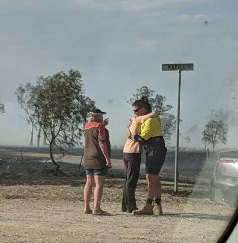 Laidley residents comfort each other after a fire tore through town houses. Picture: Ebony Graveur