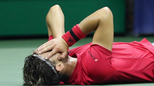 Dominic Thiem collapses to the court after defeating Alexander Zverev