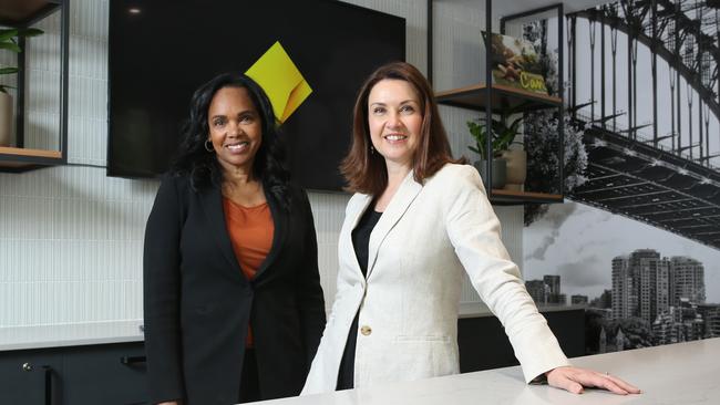 CBA Group executive marketing and corporate affairs Priscilla Brown and chief marketing officer Monique Macleod with the new CBA logo at their new branch on George St in Sydney's CBD. Picture: Britta Campion