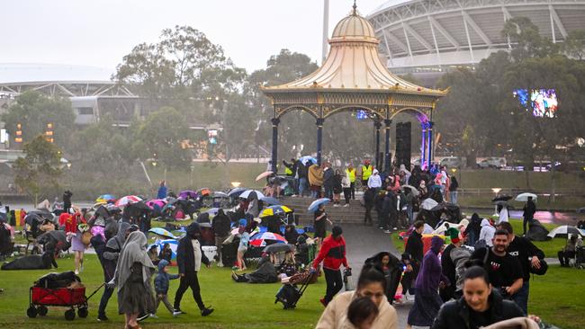 Carols by Candlelight goers flee as rain comes down on Elder Park. Picture: Morgan Sette