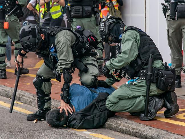 A pro-democracy supporter is detained by China’s riot police in Hong Kong. Picture: Getty Images