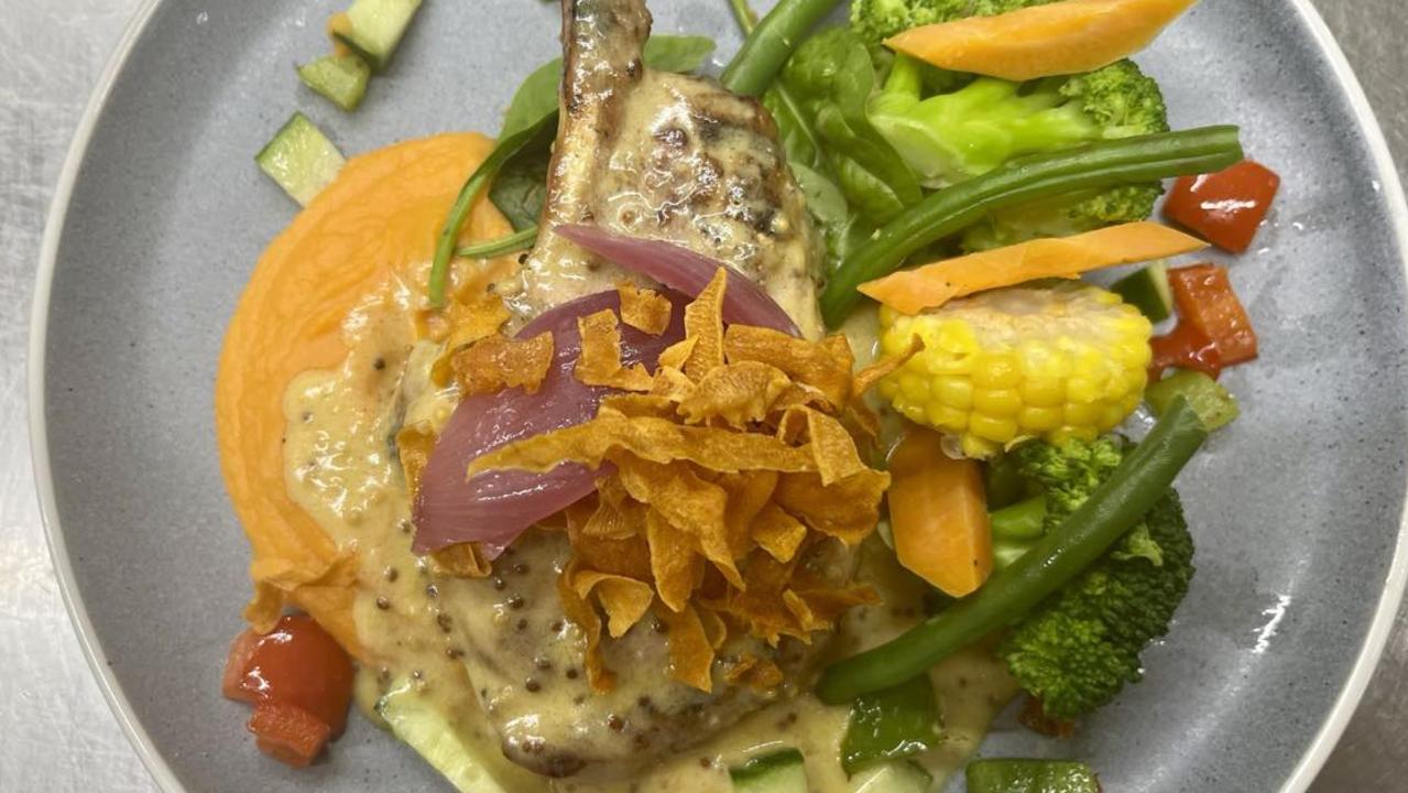 The Hinchinbrook Hotel’s Harvest Restaurant serving up a perfectly cooked, moist pork cutlet served with a delightful honey-mustard sauce, tasty sweet potato puree and crisp vegetables. Picture: Cameron Bates