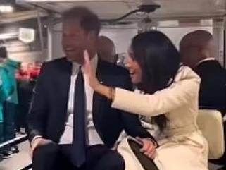 Prince Harry and Meghan Markle on the controversial golf buggy.