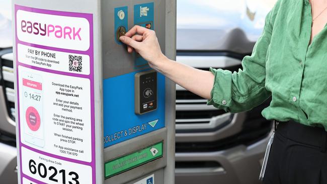 A Cairns city office worker pays for her on street cae park in the CBD at a Cairns Regional Council parking meter. Picture: Brendan Radke