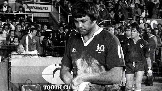 Artie Beetson walks Queensland onto the field for the inaugural State of Origin match at Lang Park in 1980.