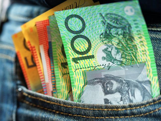 Australian cash money in mans jeans pocket, close up.