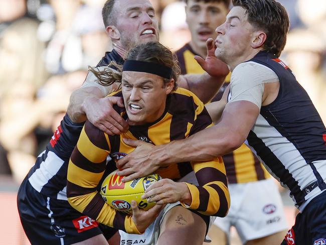 Jack Ginnivan of the Hawks tackled by Patrick Lapinski and Tom Mitchell. Picture: Michael Klein