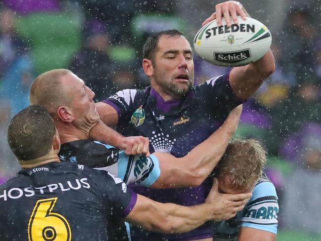 MELBOURNE, AUSTRALIA - APRIL 09:  Cameron Smith of the Melbourne Storm is tackled during the round six NRL match between the Melbourne Storm and the Cronulla Sharks at AAMI Park on April 9, 2017 in Melbourne, Australia.  (Photo by Scott Barbour/Getty Images)