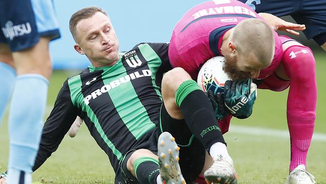 Western United striker Besart Berisha tangles with Sydney FC goalkeeper Andrew Redmayne. Picture: Getty Images