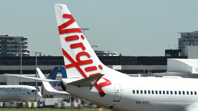 Virgin Australia aircraft a Sydney Airport in Sydney, Thursday, March 19, 2020. Qantas has suspended all international flights and will stand down two-thirds of its 30,000-strong workforce until the end of May. (AAP Image/Joel Carrett) NO ARCHIVING