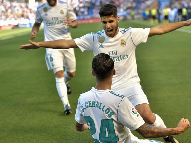 Real Madrid's Dani Ceballos, bottom, celebrates his second goal with teammate Marco Asensio