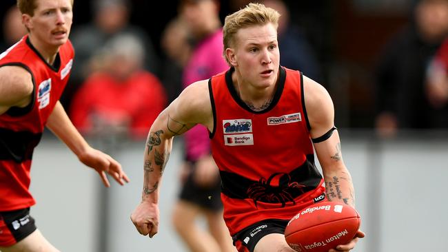 Corey Pertzel of Romsey handballs during the round 16 Riddell District Football Netball League 2023 Bendigo Bank Seniors match between Romsey and Macedon at Romsey Park in Romsey, Victoria on August 5, 2023. (Photo by Josh Chadwick)