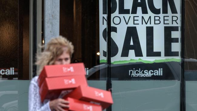 MELBOURNE, AUSTRALIA - NewsWire Photos NOVEMBER 23, 2022 Black Friday sales signs and people shopping at DFO Essendon in Melbourne. Picture: NCA NewsWire / David Geraghty