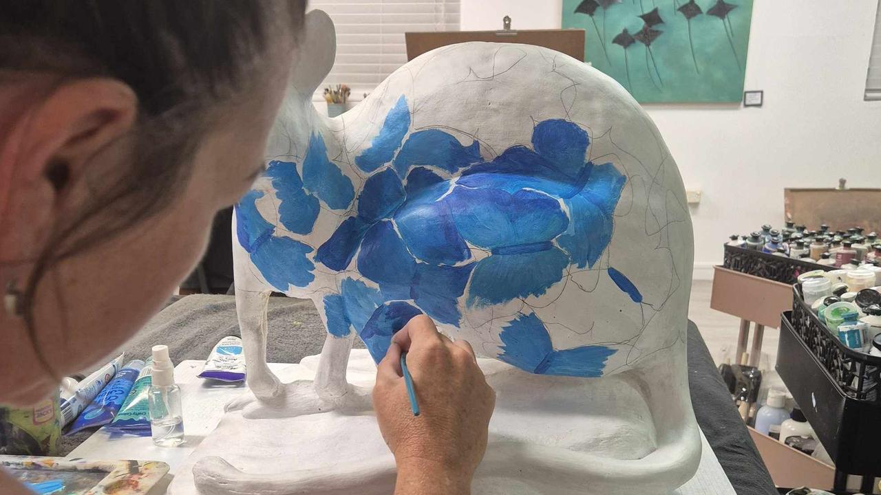 Brigitte Peel, painting her wallaby for the Proserpine Rock Wallaby Festival. Photo: Contributed