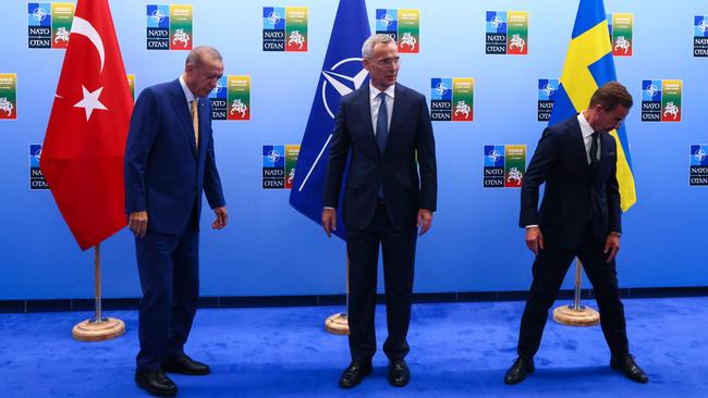 Tayyip Erdogan, Jens Stoltenberg and Ulf Kristersson find their feet before the deal to admit Sweden to NATO was clinched in Vilnius on Monday. Picture: AFP