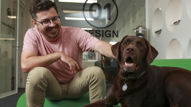 ** This is for SMART Daily page 1**Shane Talbot with his chocolate labrador, Cali, at work, at industrial design consultancy, 4Design, Surry Hills, today.Picture:Justin Lloyd.