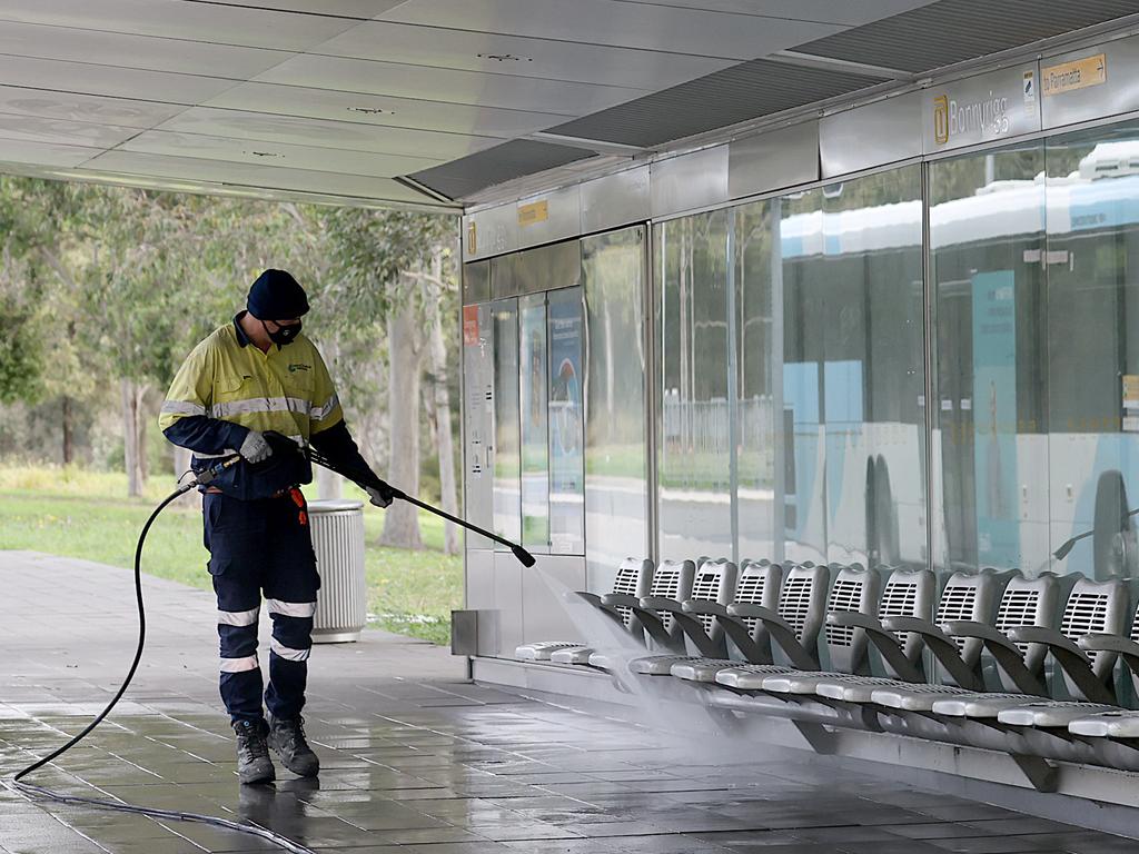 Cleaners at Bonnyrigg bus station in the southwestern Sydney suburbs during Covid-19 lockdown. Picture: Dylan Coker