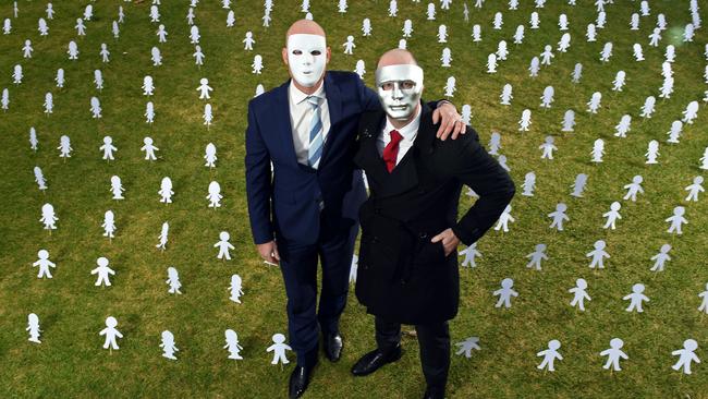 Brother A, left, and Brother B, right, surrounded by paper cut outs symbolising Australia’s child abuse victims. Picture: Tom Huntley